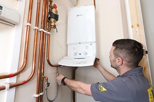 Gas Engineer Installing Boiler